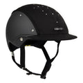 3/4 front view of A black equestrian riding Casco helmet with a matte finish, featuring a velour fabric visor and top, decorative crystals, against white background