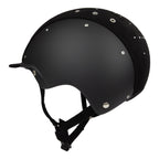 Side view of A black equestrian riding Casco helmet with a matte finish, featuring a velour fabric visor and top, decorative crystals, against white background