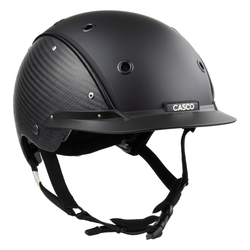 A mat black equestrian riding CASCO helmet made with mat carbon side panel, 3/4 front view against white background 