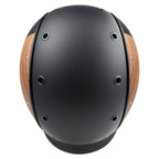 A matte black equestrian riding Casco helmet with natural wood-look panels on the sides, featuring a black chin strap, top view against white background
