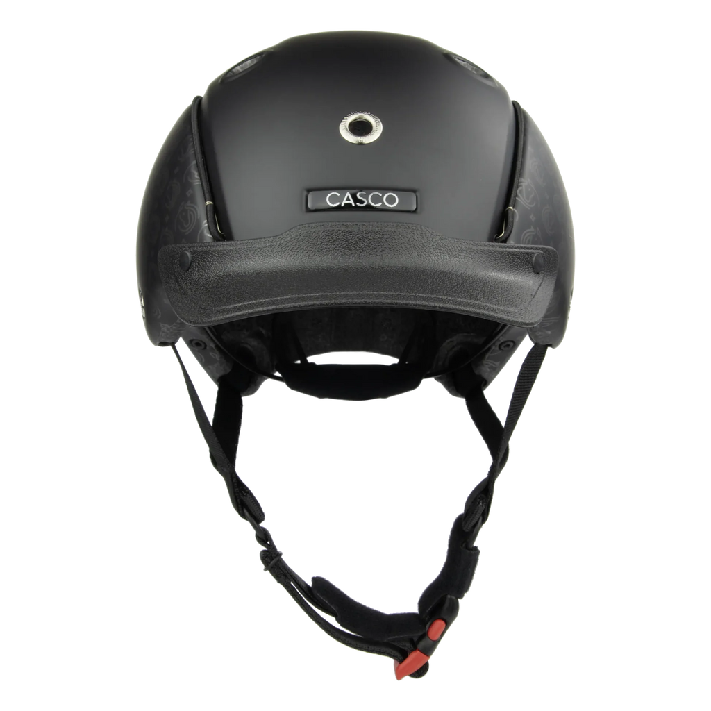 A matte black Casco helmet shown from the front against a solid white background, featuring a textured pattern on the side panels and a black chin strap with a red buckle.