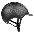 A black full-face CASCO helmet with a subtle repeating silver logo pattern, featuring a matching black visor and black chin straps with a red-and-black buckle, shown against a plain white background.