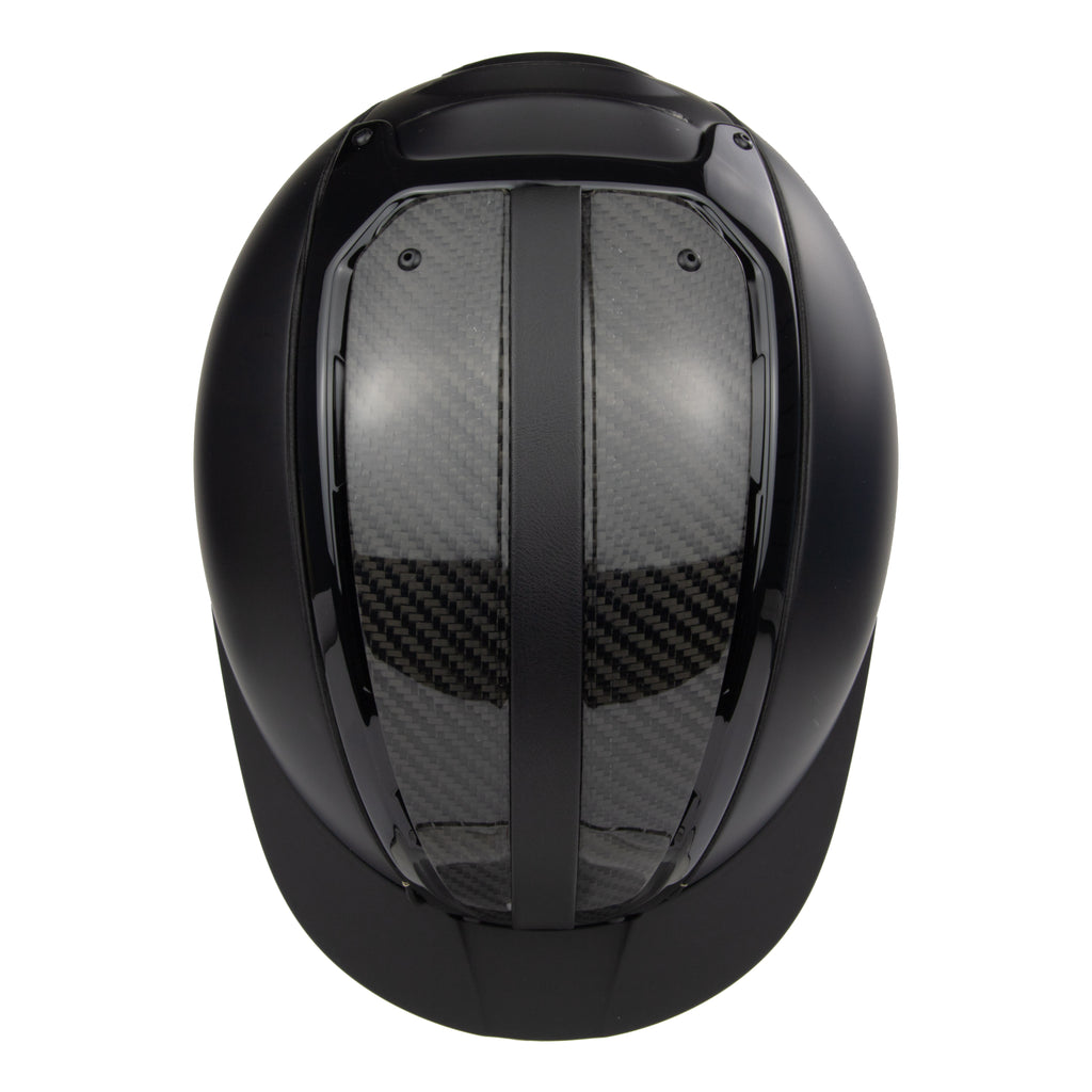 A black mat equestrian riding CASCO helmet with shiny top carbon parts, top view against white background