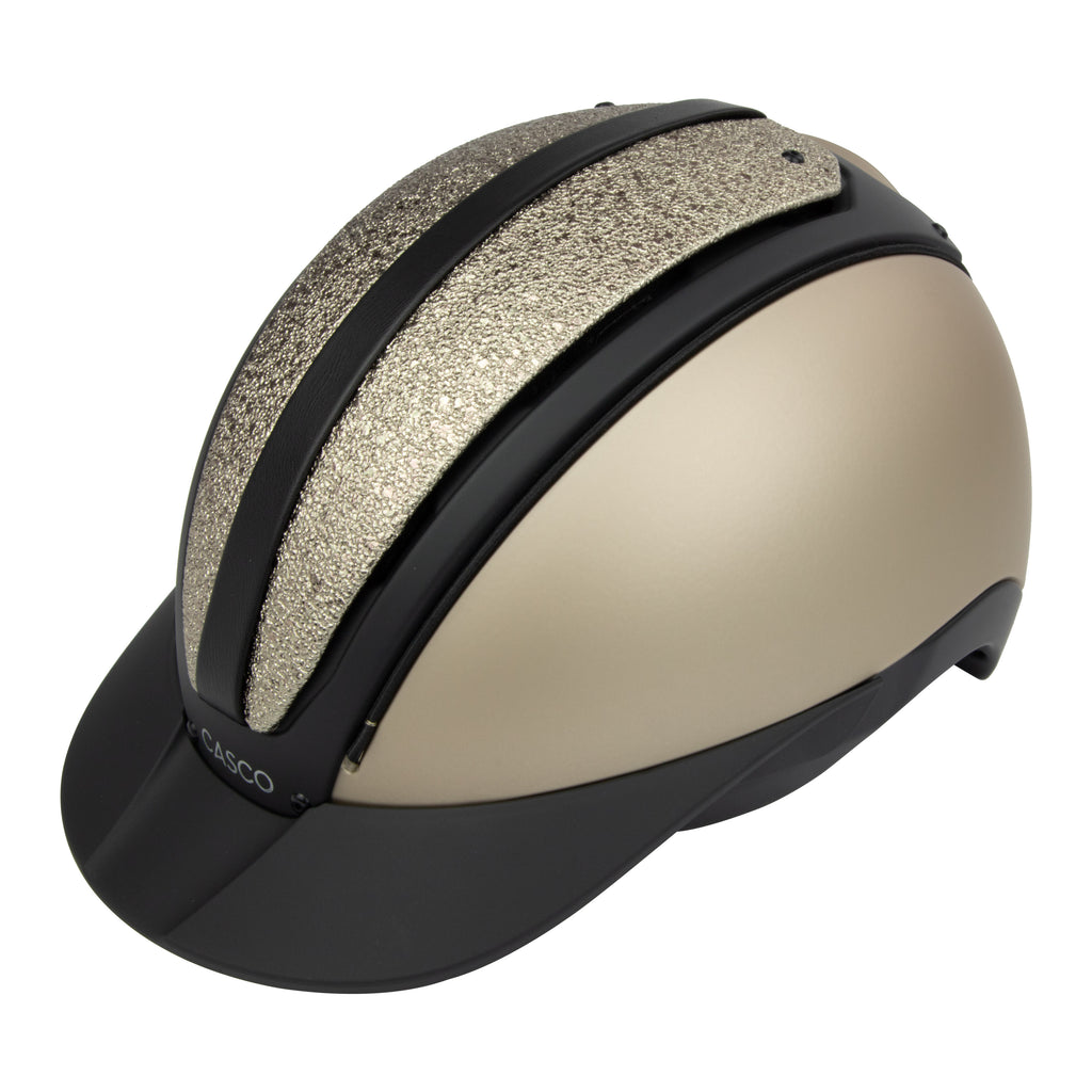A 3/4 view of the equestrian riding Casco helmet,Champagne and black contrast finish with nubuck leather detailing