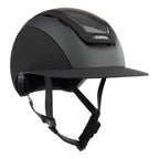 A matte black equestrian riding Casco helmet with a visor and chin straps, featuring a carbon-fiber patterned ventilation window and a visible CASCO brand badge.