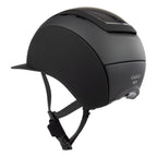 A matte black Casco Elite equestrian riding helmet with carbon top and a chin strap, shown from a three-quarters angle against a plain white background.
