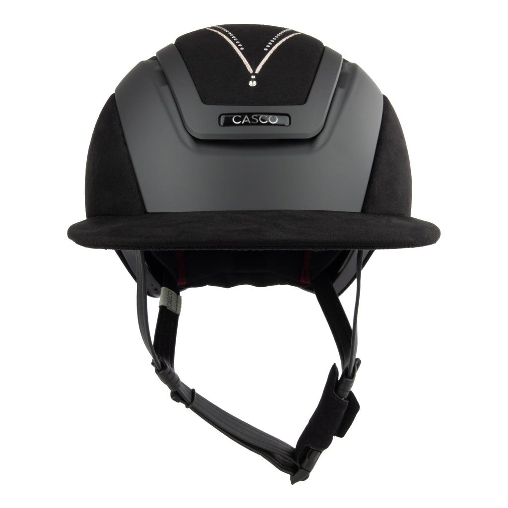 Front view of A black Casco equestrian riding helmet with a matching visor, matte finish, brushed nubuck leather with Swarovski crystals and adjustable chin strap, shown on a solid white background.
