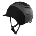 Rear 3/4 view of A black Casco equestrian riding helmet with a matching visor, matte finish, brushed nubuck leather with Swarovski crystals and adjustable chin strap, shown on a solid white background.