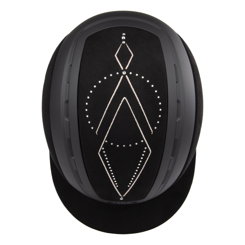 Top view of A black Casco equestrian riding helmet with a matching visor, matte finish, brushed nubuck leather with Swarovski crystals and adjustable chin strap, shown on a solid white background.