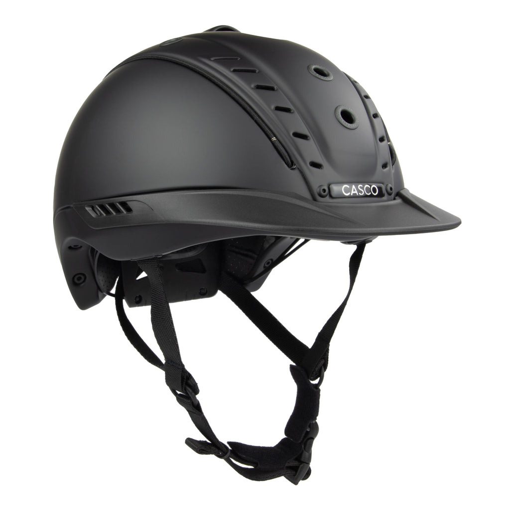A matte black Casco equestrian riding helmet with a matching visor and adjustable chin straps, shown from a three-quarters angle on a white background.