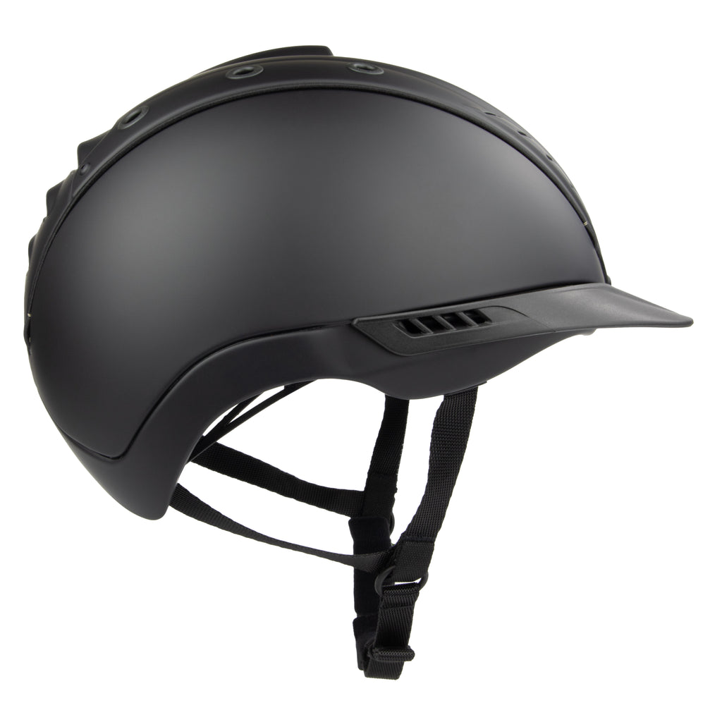 Matte black equestrian riding CASCO helmet with a visor and adjustable chin strap, shown from a side profile on a white background.