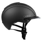 Matte black Casco equestrian helmet with a visor and black chin strap, shown from a side profile on a white background.
