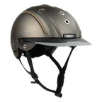 3/4 front view A matte brown equestrian riding Casco helmet with a matching visor, black chin straps, and subtle tan stitching details, shown on a plain white background.