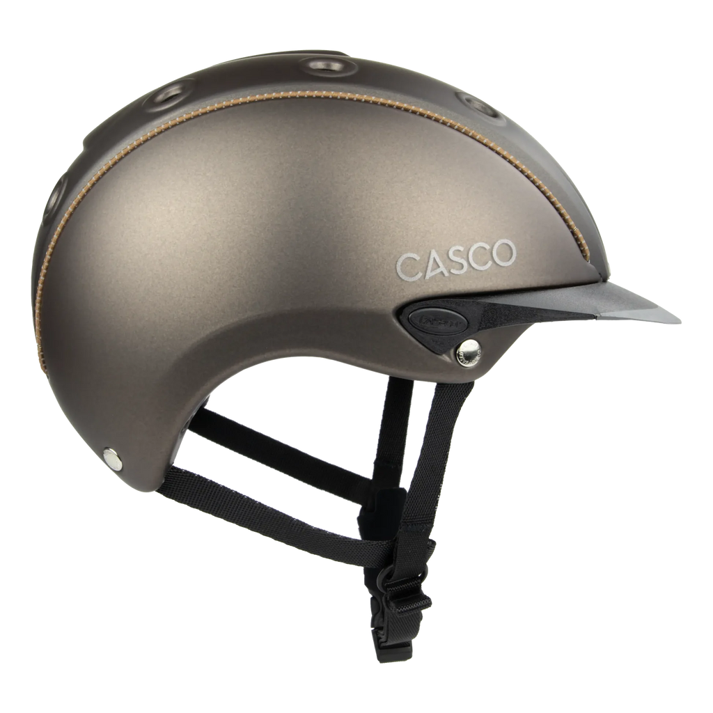 Side view A matte brown equestrian riding Casco helmet with a matching visor, black chin straps, and subtle tan stitching details, shown on a plain white background.