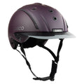 A matte dark purple Casco equestrian riding helmet with a matching visor and black chin straps, shown from a three-quarters angle on a white background.