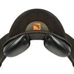 A close-up of a Childeric DPL dressage black leather saddle with an orange logo badge on the back, isolated on a white background.
