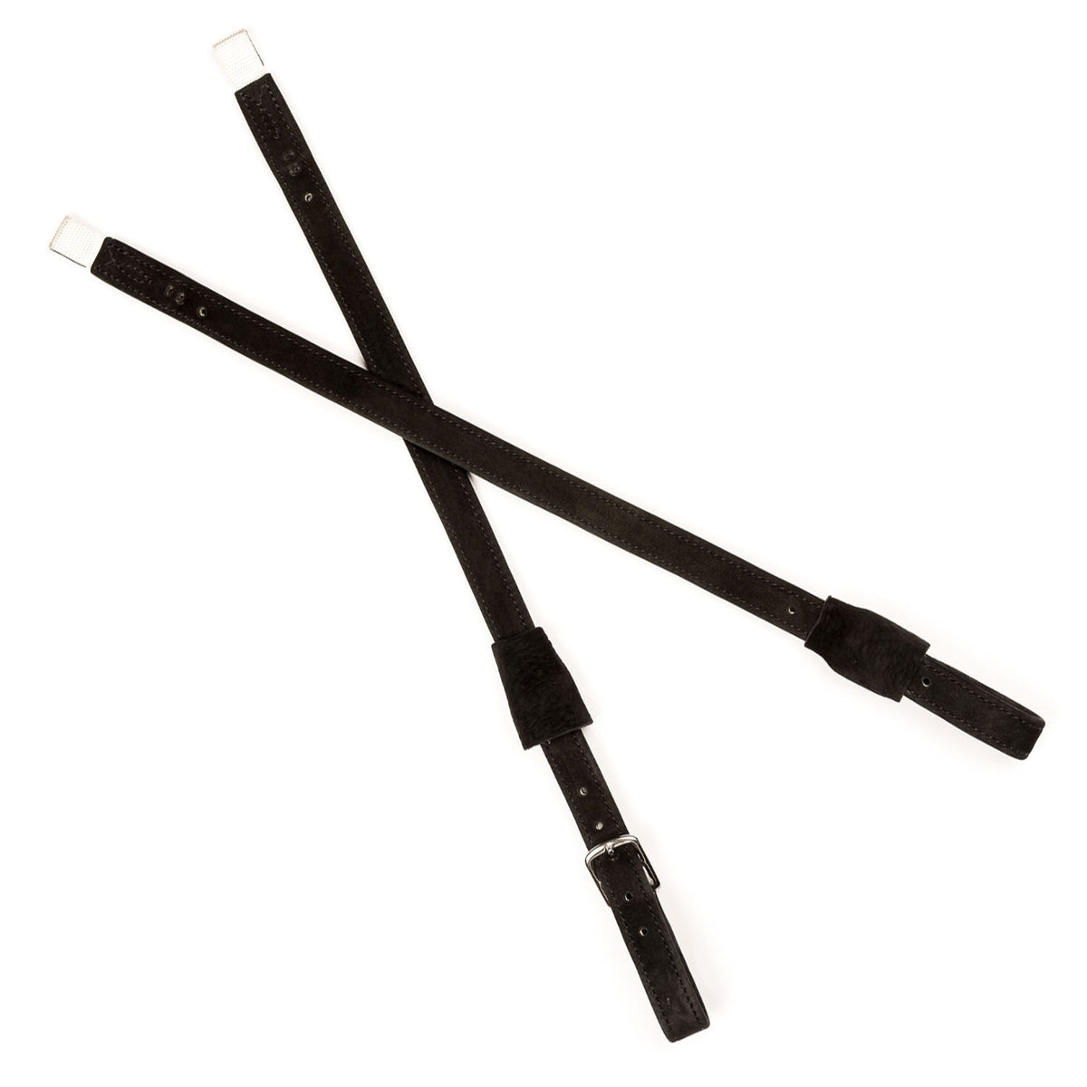 A pair of black dressage leather straps with silver metal buckles, arranged in an X-shape on a plain white background.